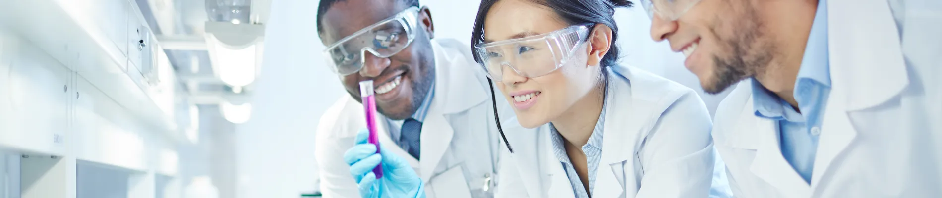 Students in lab coats collaborating