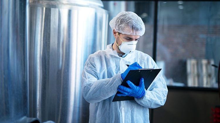 concentrated-technologist-expert-white-suit-controlling-production-750px.jpg