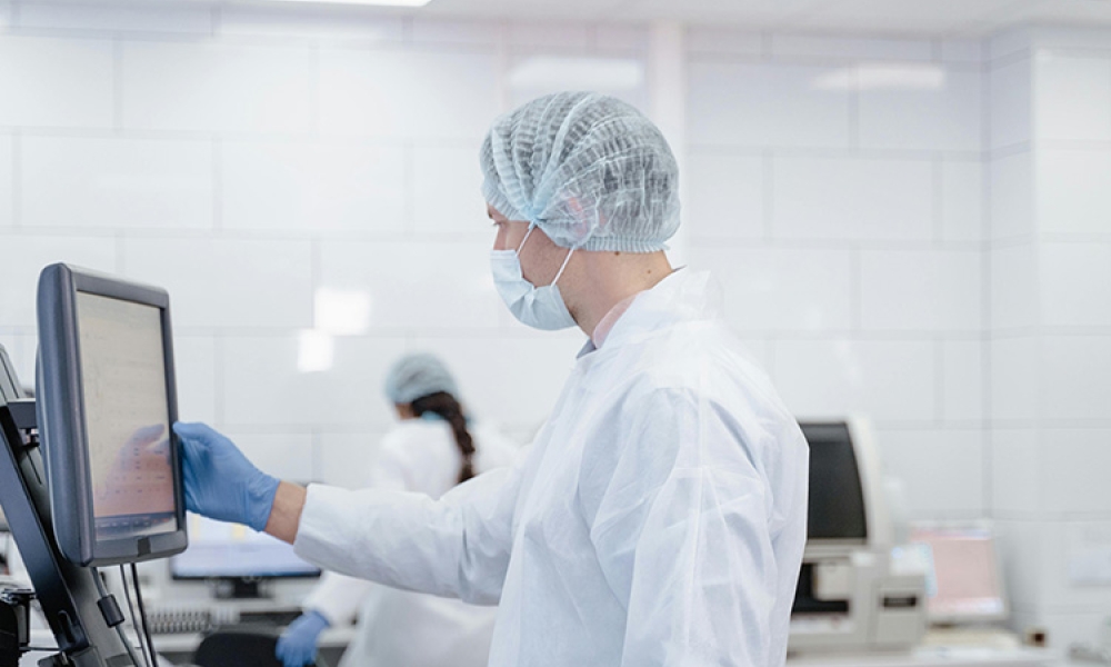 a-man-in-white-lab-gown-touching-a-computer-screen-pexels-tima-miroshnichenko