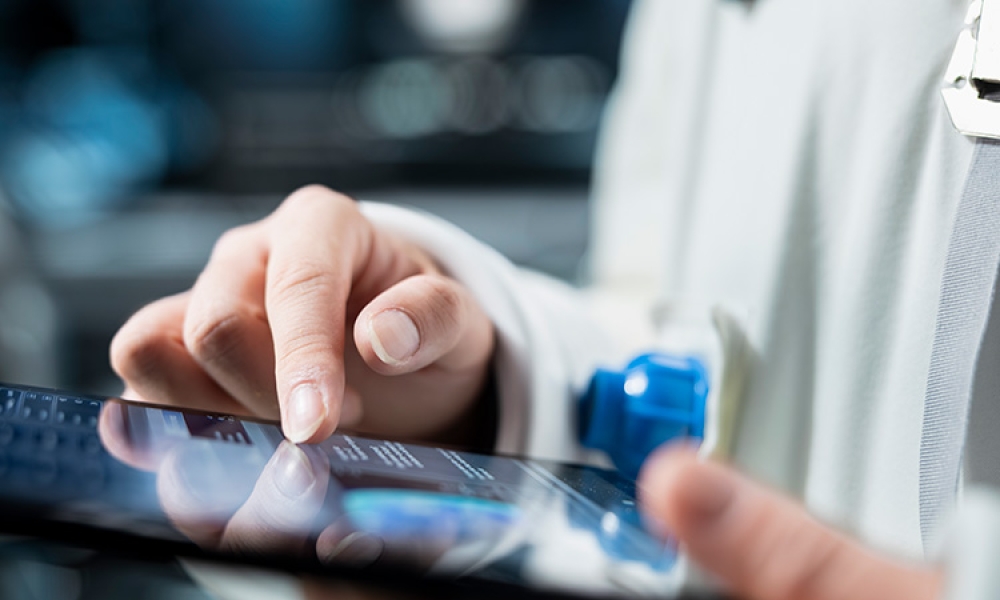 close-up-technician-reviewing-metrics-tablet-750px.jpg
