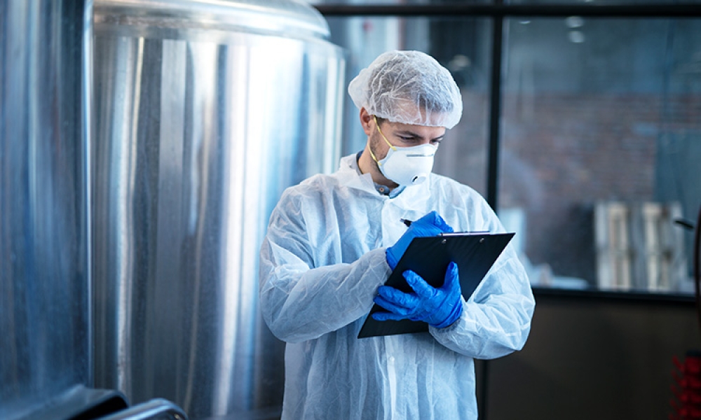 concentrated-technologist-expert-white-suit-controlling-production-750px.jpg
